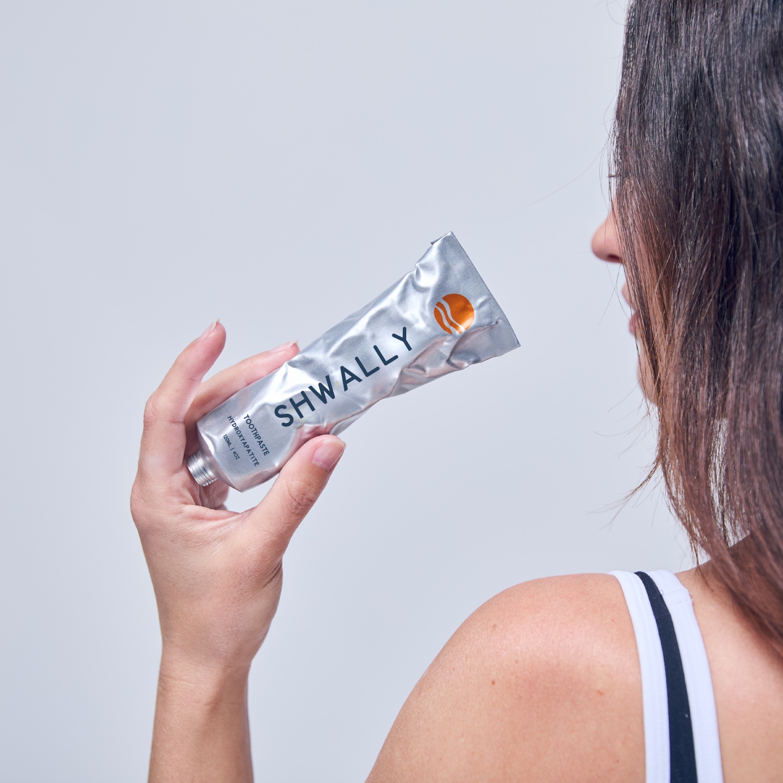 Model holding Shwally Toothpaste- Shwally